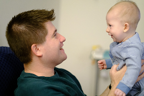 Man holding his baby and looking at each other